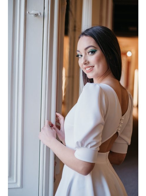 Fehér mini ruha, puffos ujjakkal és különleges hátkivágással.